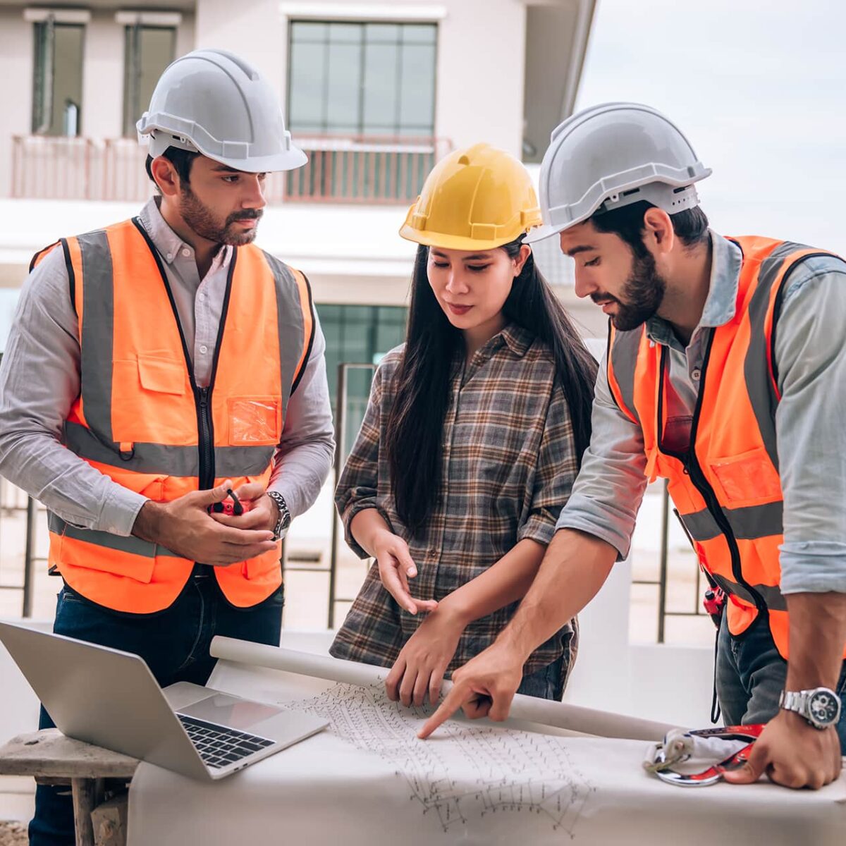 civil-engineer-construction-worker-architects-wearing-hardhats-safety-vests-are-working-together-construction-site-building-home-cooperation-teamwork-concept