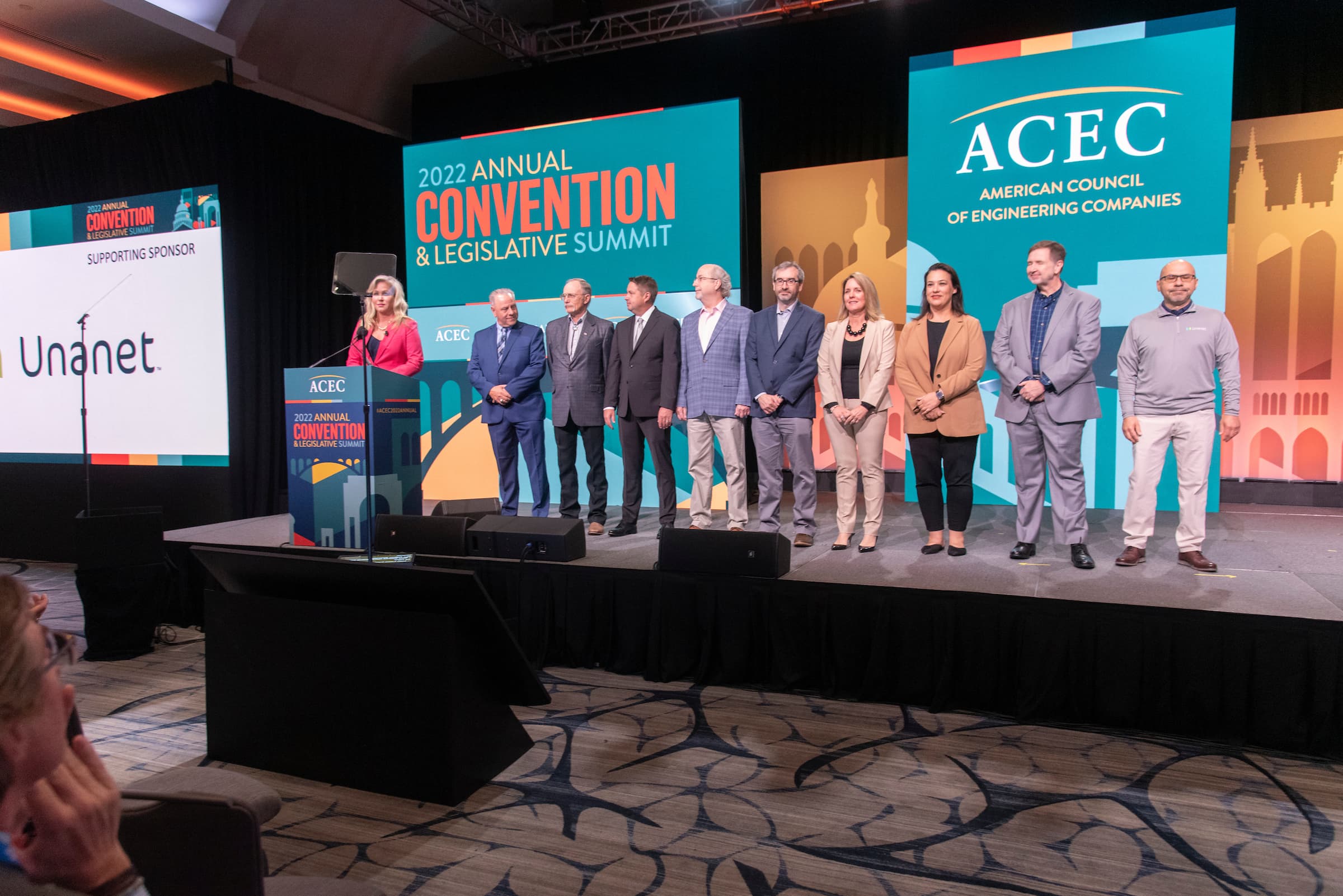 Awardees and other members standing on the stage during the ACEC 2022 annual convention and legislative summit