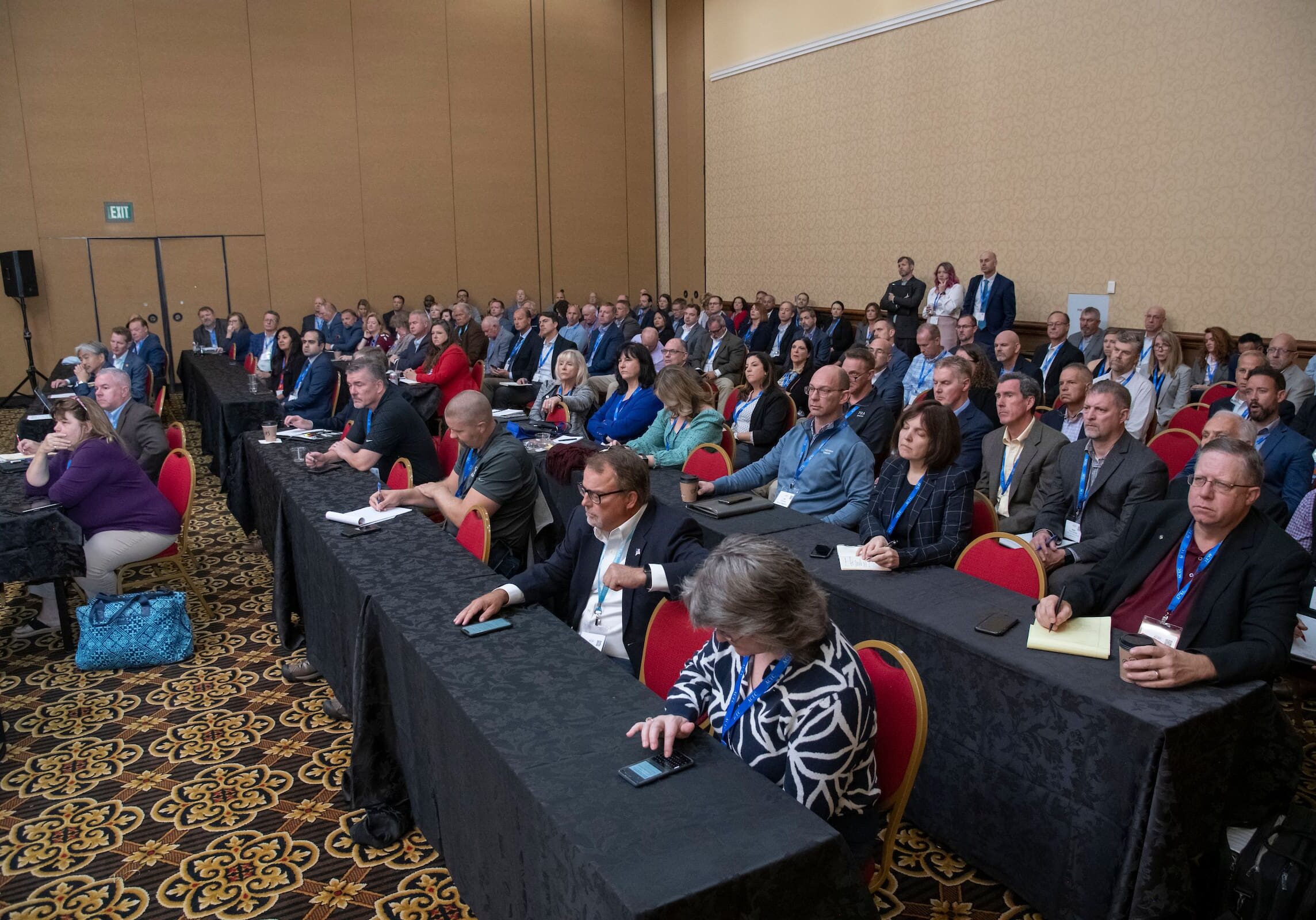 acec members sitting while taking notes during a conference