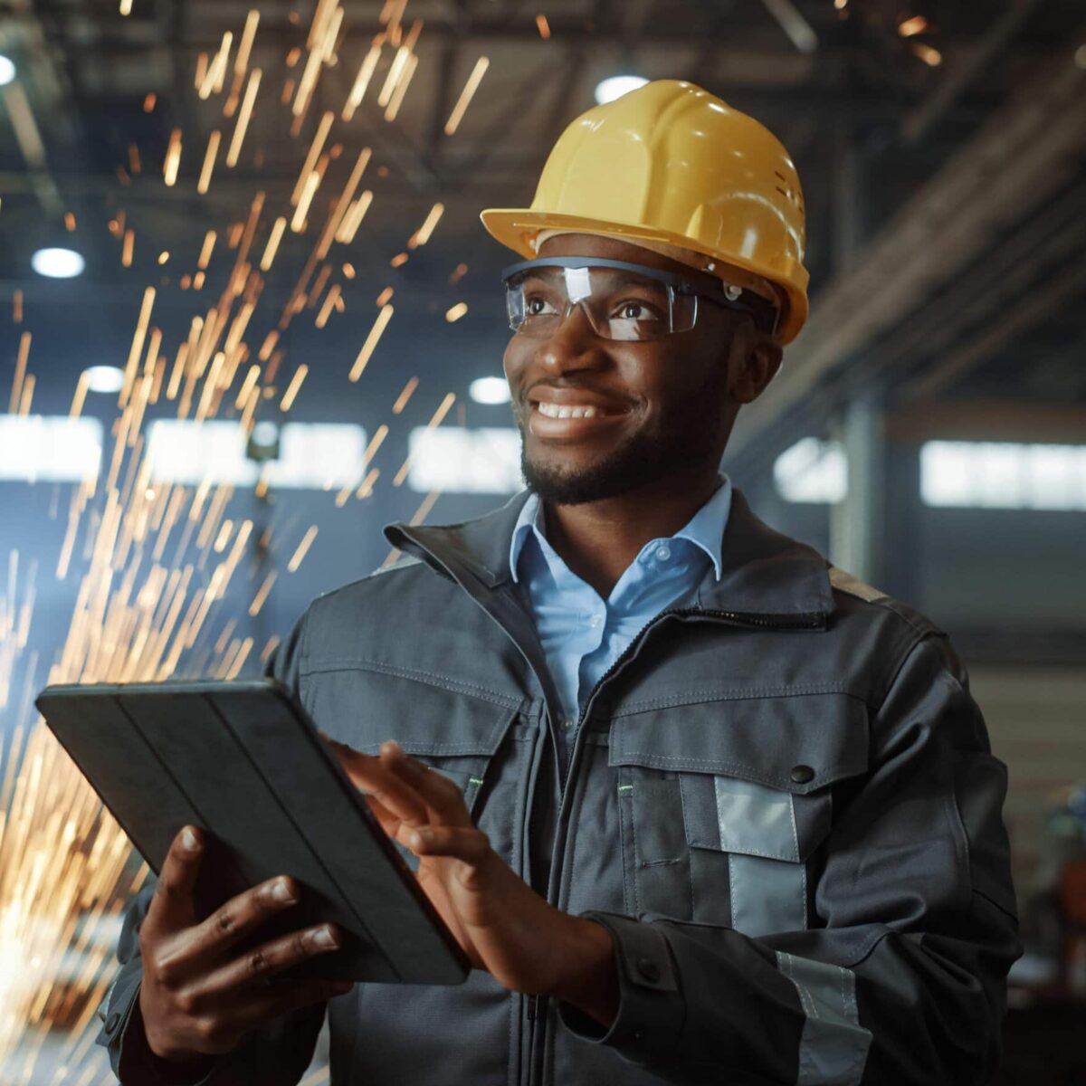 Professional Heavy Industry Engineer Worker Wearing Safety Uniform and Hard Hat Uses Tablet Computer